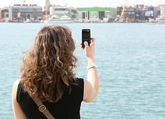 Tourist on holiday using mobile cell phone